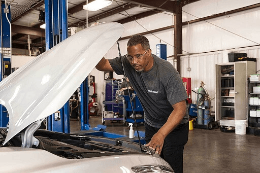 A Meineke mechanic working on a Starter Repair and Alternator Rebuild